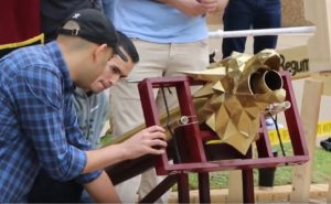 Students adjusting a homemade ballista as part of the class siege engine competition